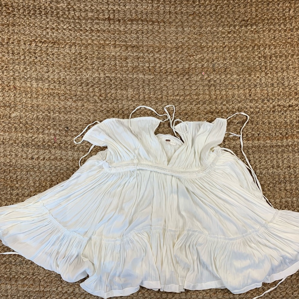 Goes on like a blouse, and has straps that tie behind neck
